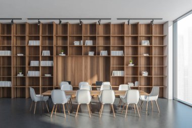 Bir konferans odasının panoramik beyaz ve gri iç kısımlarında çalışma masası olan duvardan duvara & tavandan tavana raflar. Beton zemin. Modern tasarım konsepti. 3d oluşturma