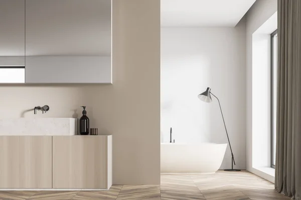 镜像橱柜和虚荣旁边的米色隔墙和一个白色浴室内部与最低限度的灯具设计和一个椭圆形陶瓷浴缸的背景 3D渲染 — 图库照片