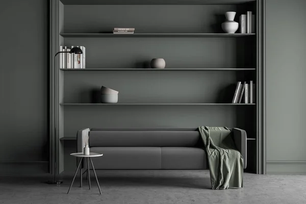Dark living room interior with comfortable sofa, books, shelves, crockery, lamp and concrete floor. Concept of place for relaxation in minimalist scandinavian design. 3d render
