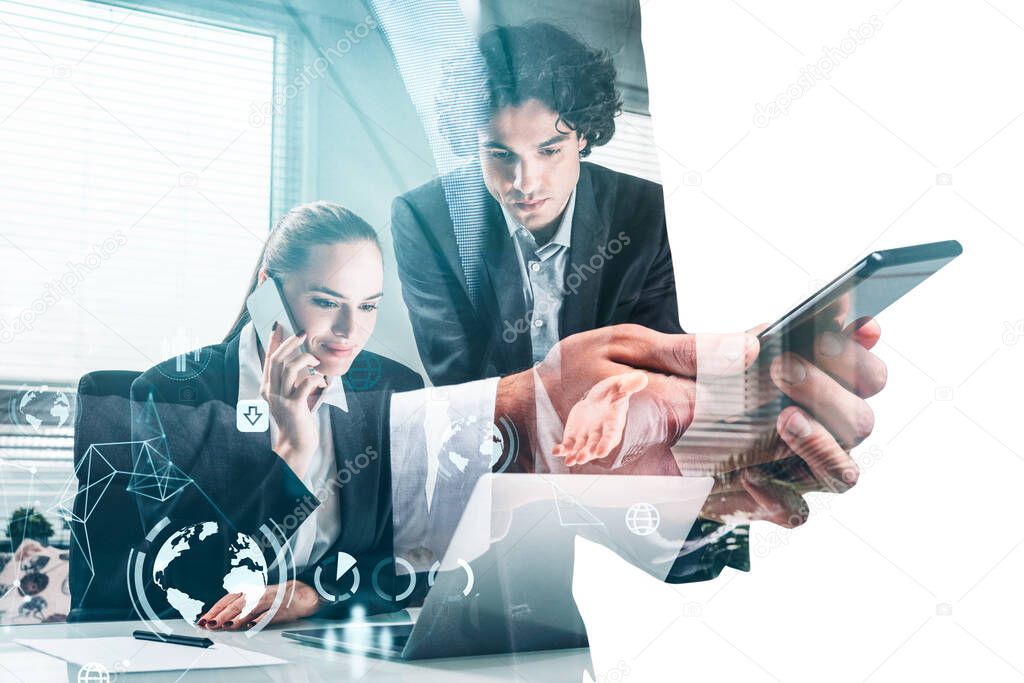 Serious young businessman and attractive businesswoman are working together and having a conference call on laptop. Office in the background. Concept of teamwork, cooperation and online meeting