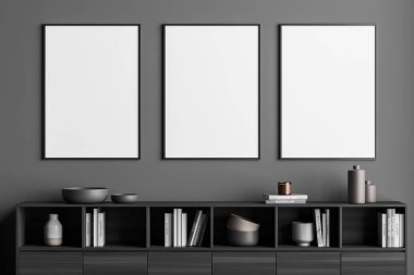 Gri oturma odasındaki tasarımın için üç sıra çerçeveli poster. Duvarın içi ve ahşap büfe. Modern minimalist ev kavramı. 3d oluşturma