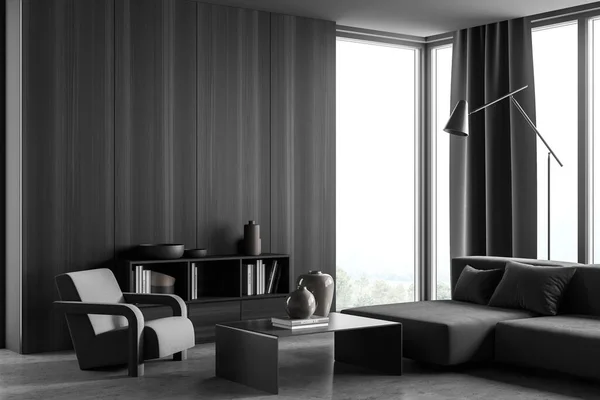 Corner of the dark grey panoramic living room interior with wooden wall cover, sofa, armchair, curtain, coffee table, sideboard and lamp. Concrete floor. A concept of modern house design. 3d rendering