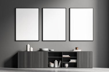 Oturma odasının koyu gri duvarında üç sıra maket poster var. Büfe ve beton döşeme için ahşap malzeme kullanan modern ev tasarımı. Minimalist bir kavram. 3d oluşturma.