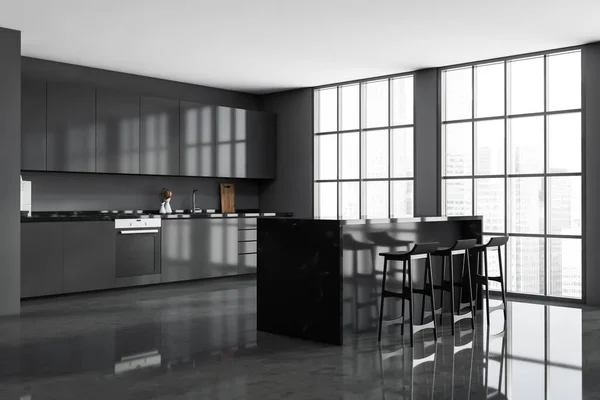 Corner view of the panoramic grey kitchen room interior with the breakfast bar table, three stools and a kitchen cabinet. Concrete floor. A concept of modern apartment design. 3d rendering
