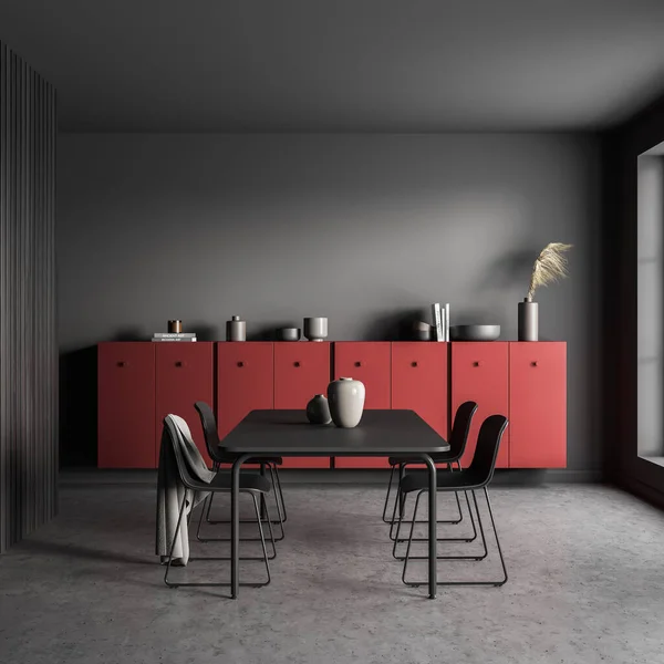 Black dining table with four chairs in the grey living room interior with accent red sideboard. Concrete floor. A concept of modern living space design. 3d rendering