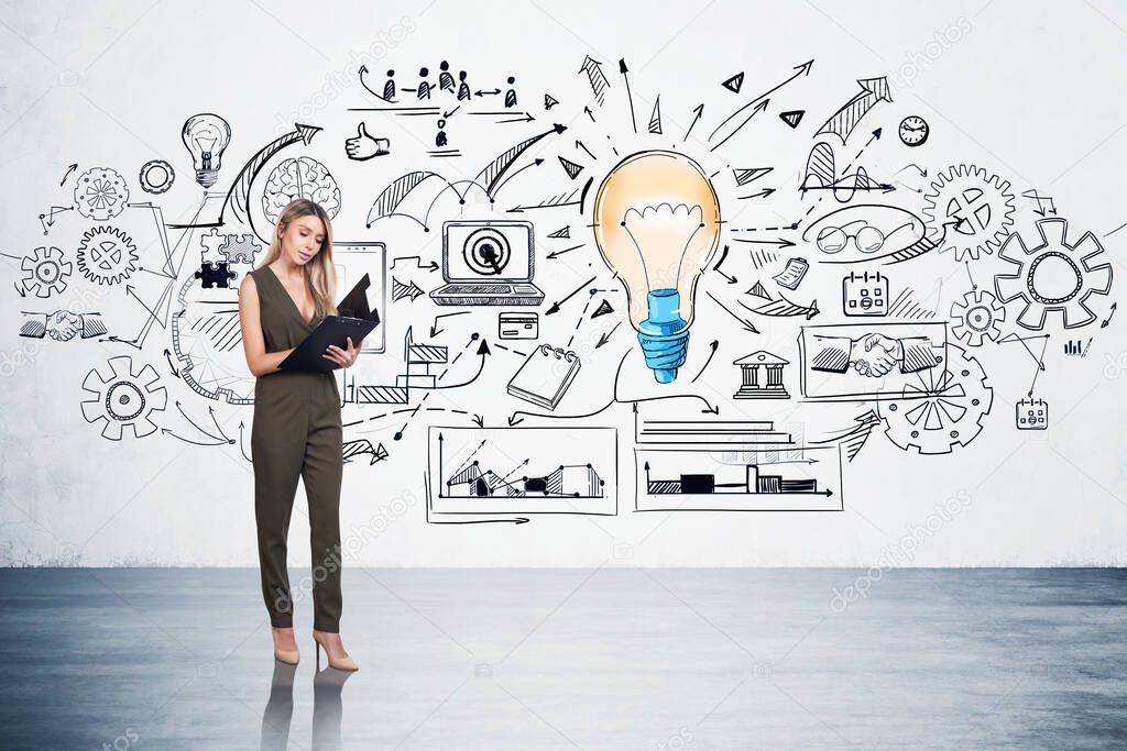 Businesswoman in green dress t is standing near colourful sketch with large light bulb, notebook, brain, cogwheel, puzzle on concrete wall. Concept of imagination for creative ideas