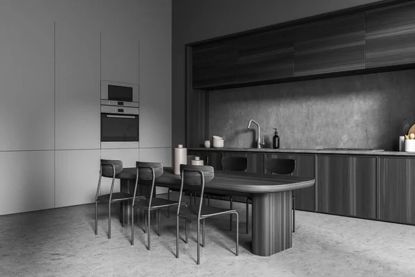 ダイニングテーブル 6椅子 コンクリート床 電気炊飯器 ストーブ付きの暗いキッチンルームのインテリアのコーナービュー 現代的なミニマリストデザイン 料理に最適な場所です 3Dレンダリング — ストック写真