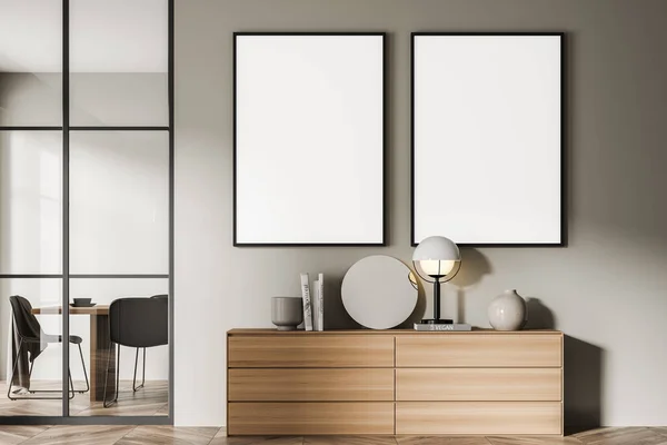 Two canvases on the beige wall of the living room area with a modern sideboard. A dining room behind a frame glass wall partition on the background. Parquet. Mock up. Minimalist concept. 3d rendering