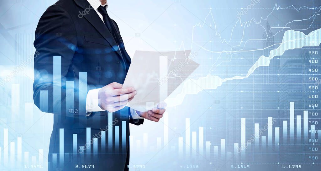 Businessman wearing formal suit is holding and reading document on paper. Financial graph and chart and bar diagram in the foreground. New York city skyscraper in the background. Concept of trading
