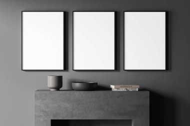 Koyu gri duvarda üç boş beyaz tuval. Şöminenin üstünde vazolar ve kitaplar olan çağdaş bir şömine. Modern oturma odası tasarımı kavramı. Model yap. 3d oluşturma
