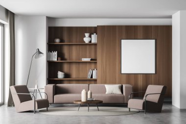 Kahverengi mobilyaları, minimalist bir lambası ve beton zemini olan beyaz ve gri oturma odasındaki koyu ahşap kitap dolabının üzerindeki boş kare tuval. Model yap. Modern ev tasarımı kavramı. 3d oluşturma