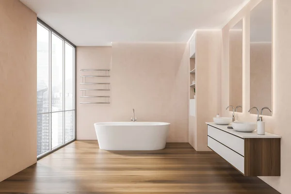 On-trend panoramic bathroom interior with pink concrete walls, a white bathtub, two sinks, an elegant rack and dark wood-look flooring. A concept of modern apartment design. 3d rendering