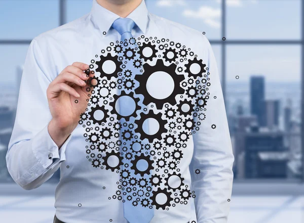 Businessman drawing gears — Stock Photo, Image