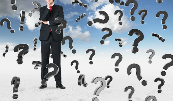 Businessmanand falling question marks — Stock Photo, Image