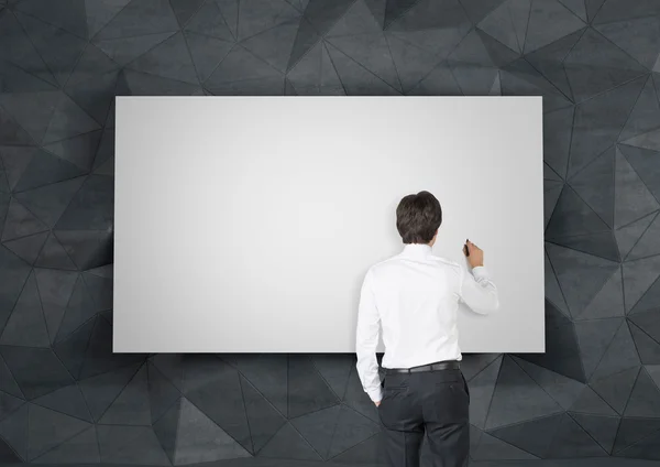 Businessman drawing on placard — Stock Photo, Image