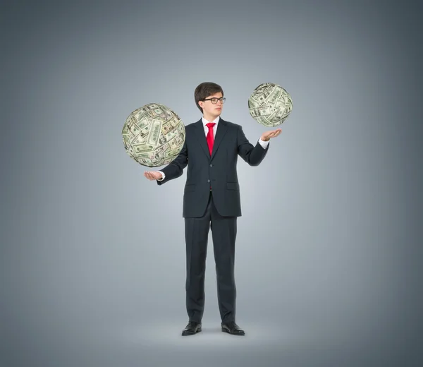 Businessman holding dollar sphere — Stock Photo, Image