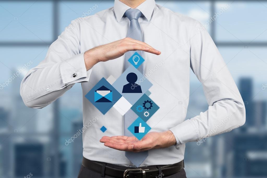 businessman holding business icons