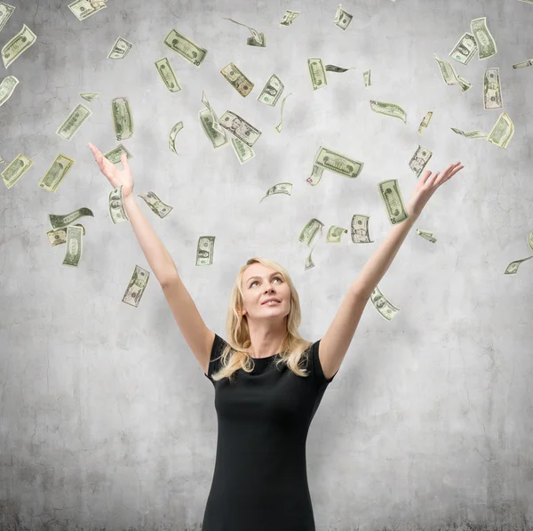 Woman with falling dollars banknote — Stock Photo, Image