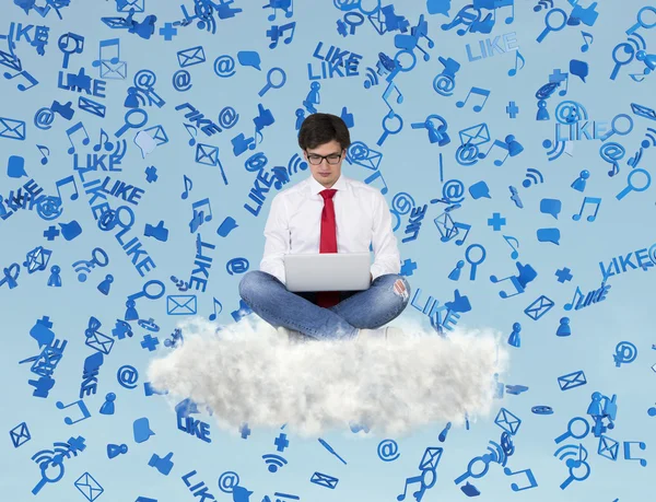 Businessman sitting on cloud with laptop — Stock Photo, Image