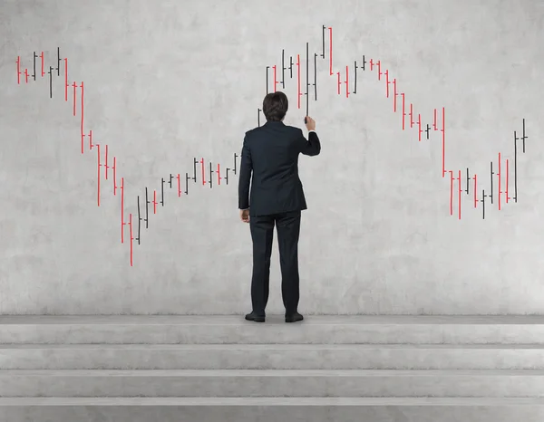 Man drawing stock chart — Stock Photo, Image