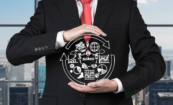 Businessman holding business symbols — Stock Photo, Image