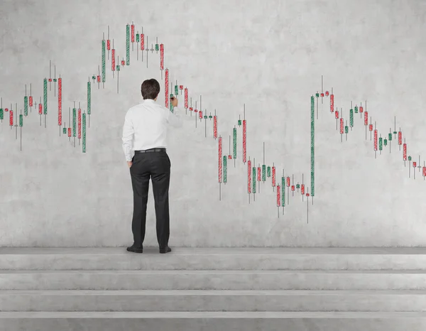 Businessman drawing stock chart — Stock Photo, Image