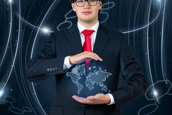 Young businessman  holding world map — Stock Photo, Image