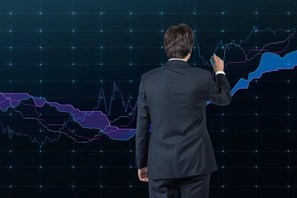 Businessman drawing stock diagram — Stock Photo, Image