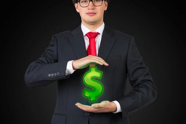 Бизнесмен, держащий зеленый доллар — стоковое фото
