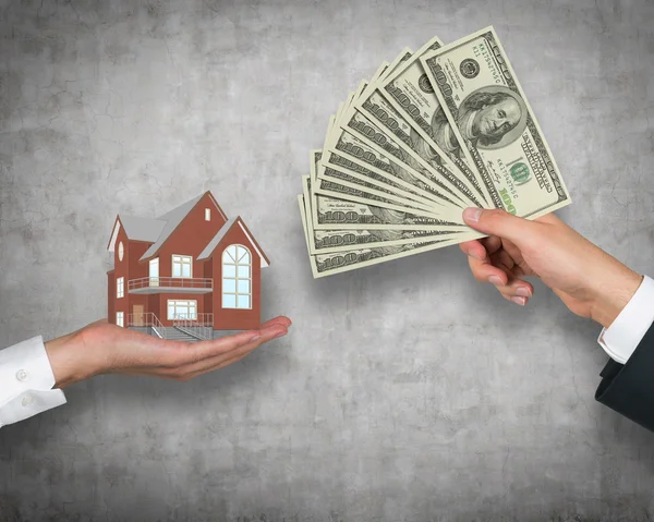 Hand giving money for housing — Stock Photo, Image