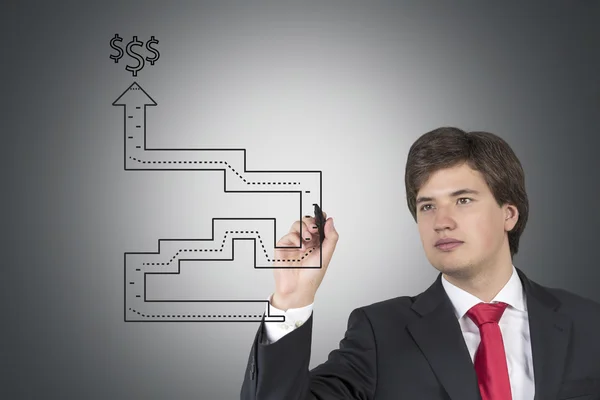 Businessman drawing labyrinth — Stock Photo, Image