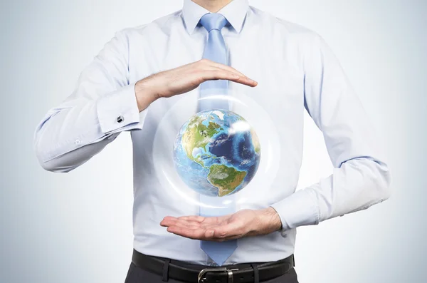 Businessman holding planet — Stock Photo, Image