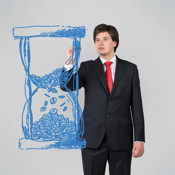 Businessman drawing hourglass — Stock Photo, Image