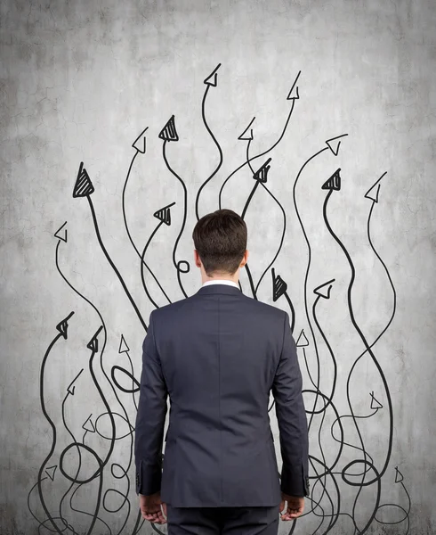 Businessman and drawing arrows — Stock Photo, Image