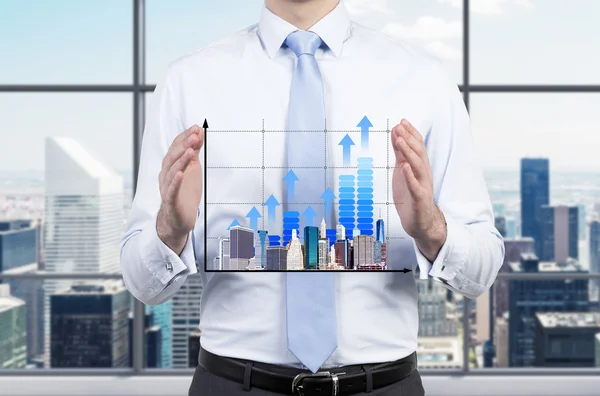 Chart and skyscraper in hand — Stock Photo, Image