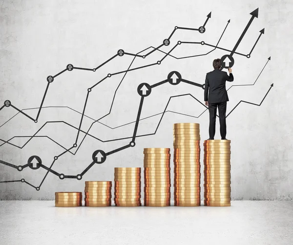 Businessman standing on coins — Stock Photo, Image