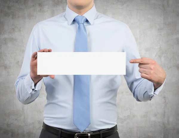 Businessman holding a poster — Stock Photo, Image