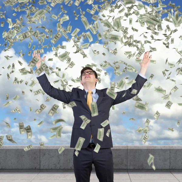 Businessman and flying dollars — Stock Photo, Image