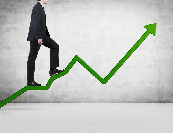 Businessman walking on chart — Stock Photo, Image