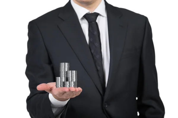 Businessman handing silver coins — Stock Photo, Image