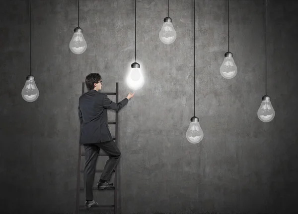 Businessman on ladder — Stock Photo, Image