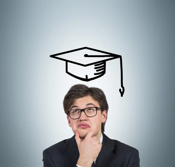 Student in drawing bachelor hat — Stock Photo, Image