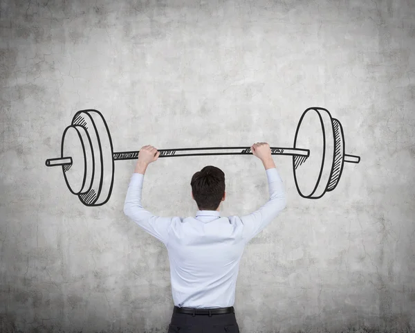 Empresário segurando barbell — Fotografia de Stock