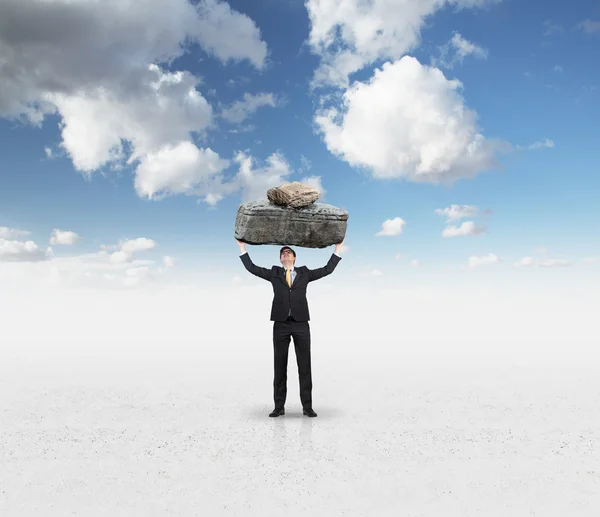 Businessman holding stone — Stock Photo, Image