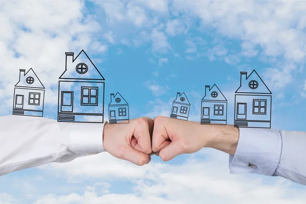 Two fist with houses — Stock Photo, Image