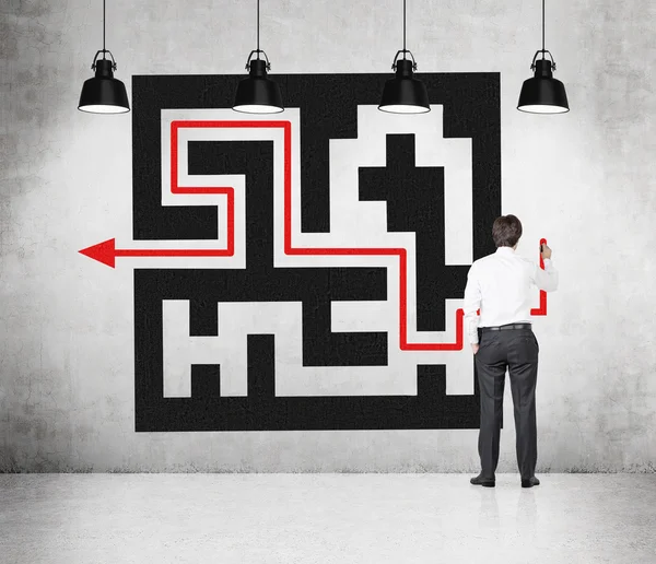 Businessman drawing maze — Stock Photo, Image