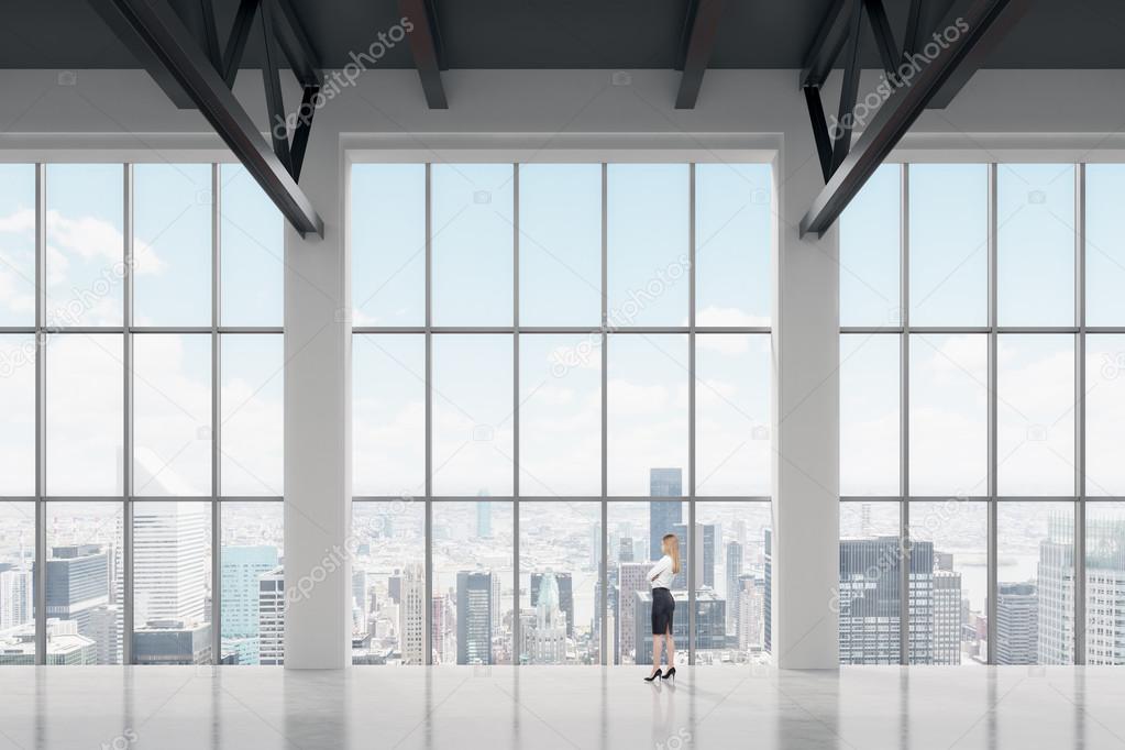Businesswoman looking through the window in office
