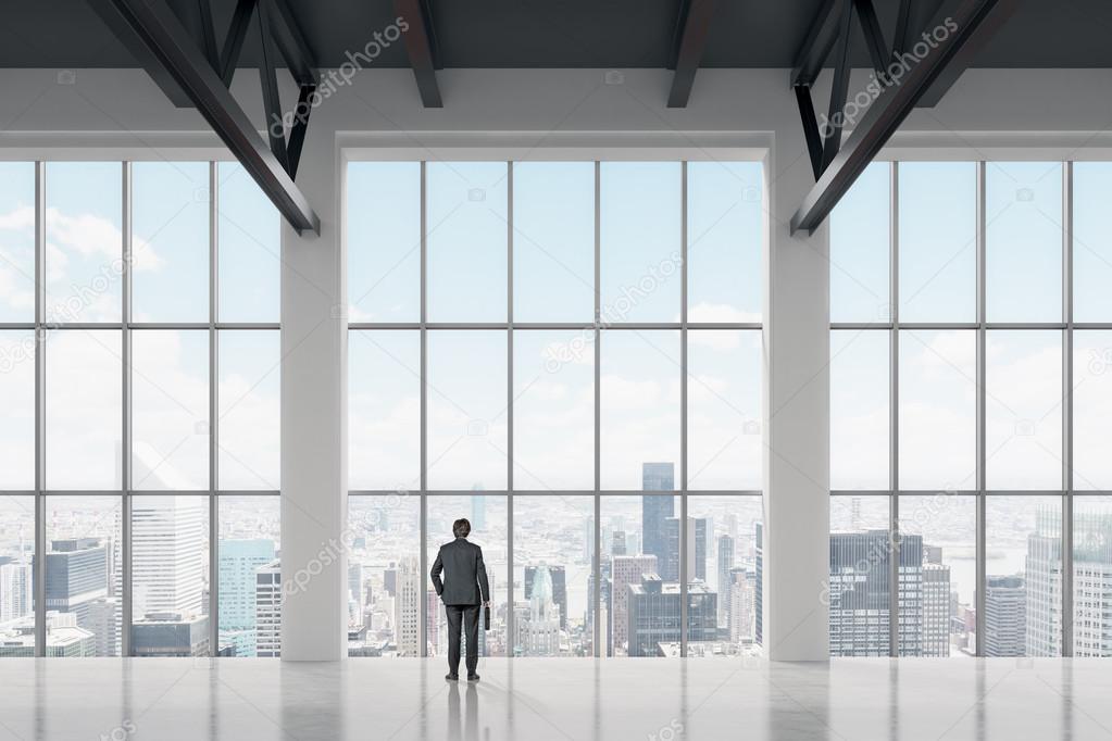 Businessman looking through the window in office