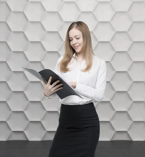 Young business lady is looking at the file. Contemporary background. — Stock Photo, Image