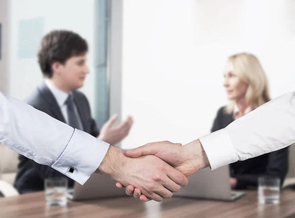 Young couple at the business meeting. Handshake as a concept of successful deal. — Stock Photo, Image